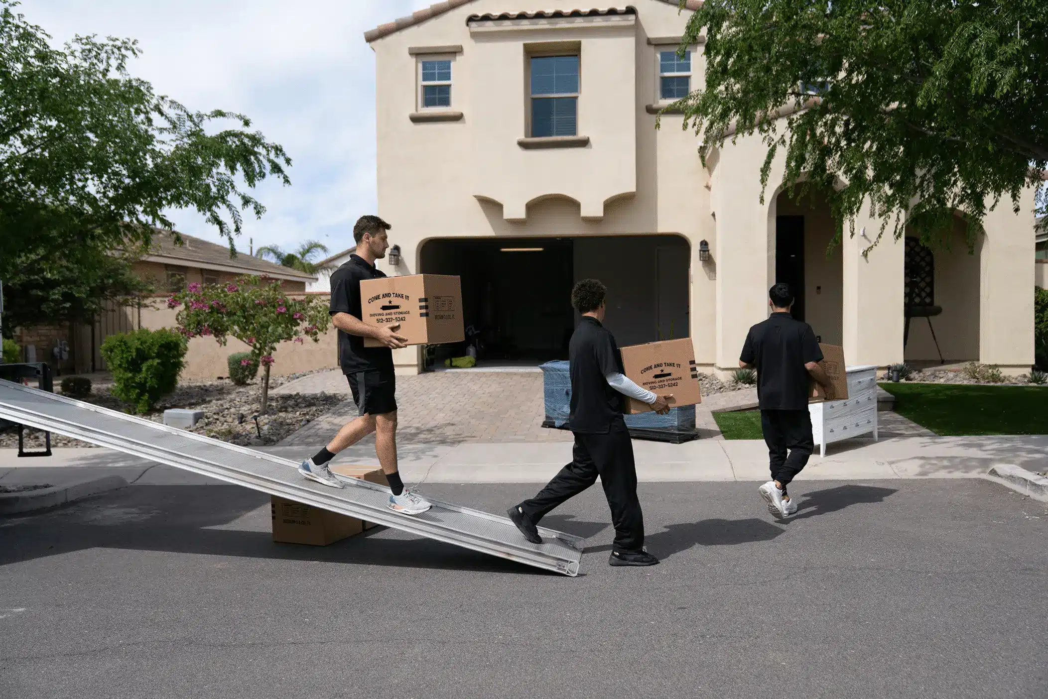 Come and Take it movers in action carrying boxes